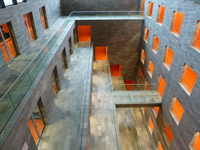 Verwinkelter Innenhof eines Gebäudes mit orangen Plissees.